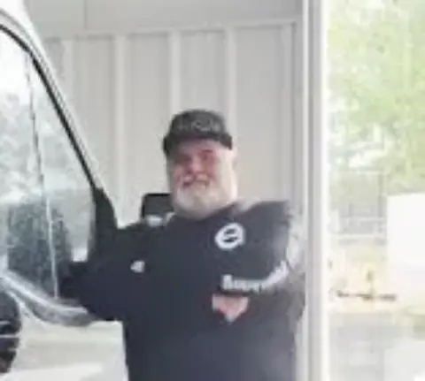 Steve Pillon, owner and master plumber, standing in front of his work van